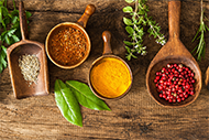 Dry spices in wooden dishes and spoons Dry spices in wooden dishes and spoons
